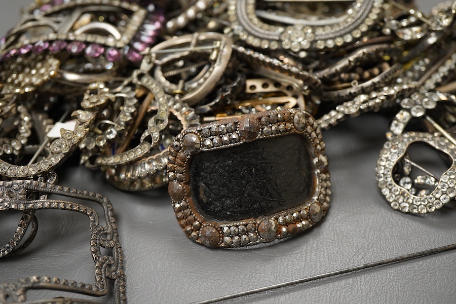 A large collection of buckles, 18th-early 20th century, of oval and rectangular outline, set with pastes, some with cut steel, mostly mounted in steel, a minority in silver, some with later brooch fittings
